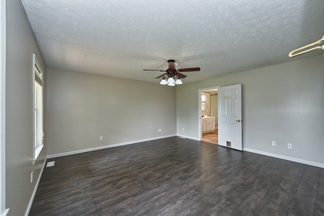 unfurnished room with dark hardwood / wood-style flooring, a textured ceiling, and ceiling fan