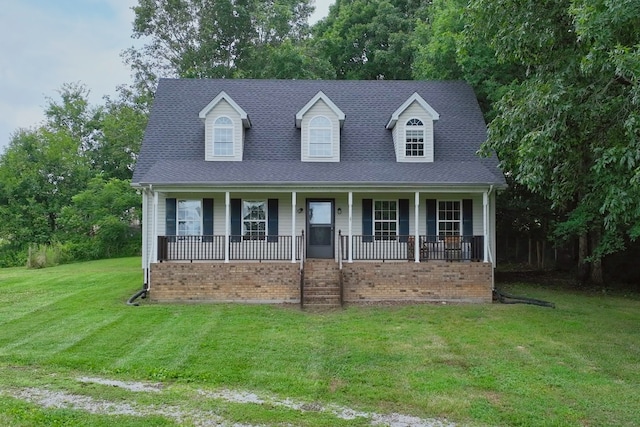 cape cod-style house with a front yard and covered porch