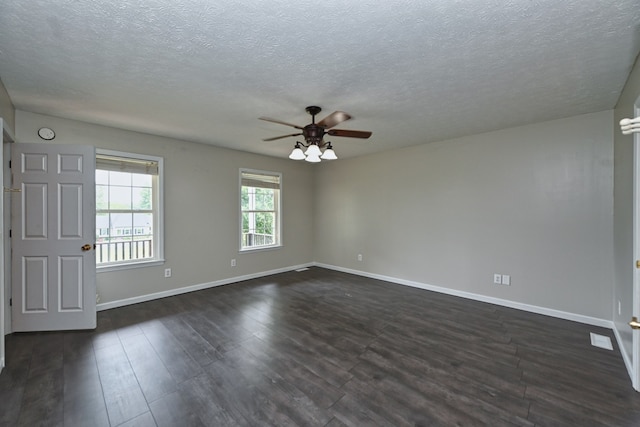 spare room with a textured ceiling, dark hardwood / wood-style flooring, and ceiling fan