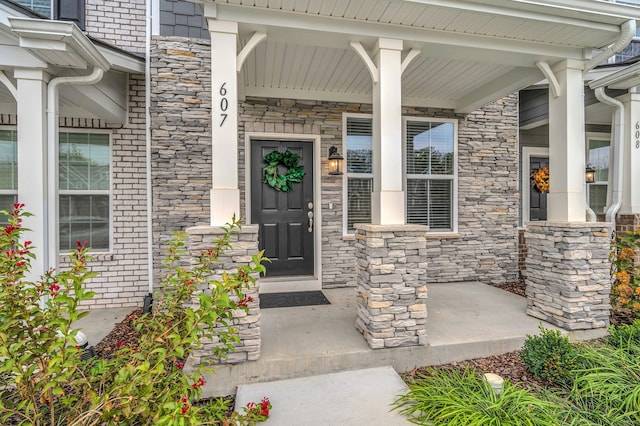 doorway to property featuring covered porch