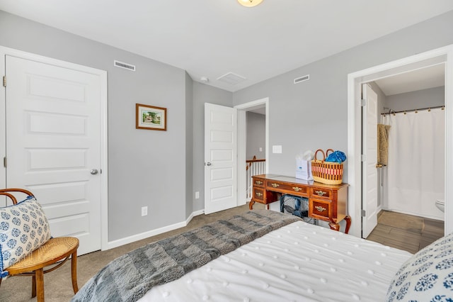 bedroom featuring dark hardwood / wood-style flooring and ensuite bathroom