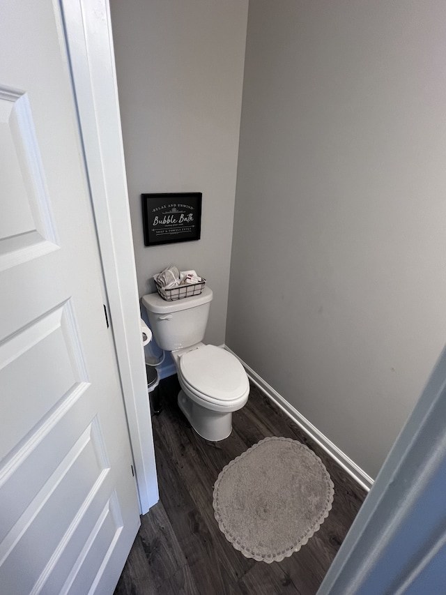 bathroom with hardwood / wood-style floors and toilet