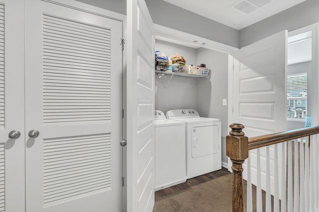 laundry room with washing machine and clothes dryer and dark hardwood / wood-style floors