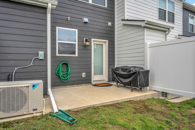 view of patio / terrace with a grill and ac unit