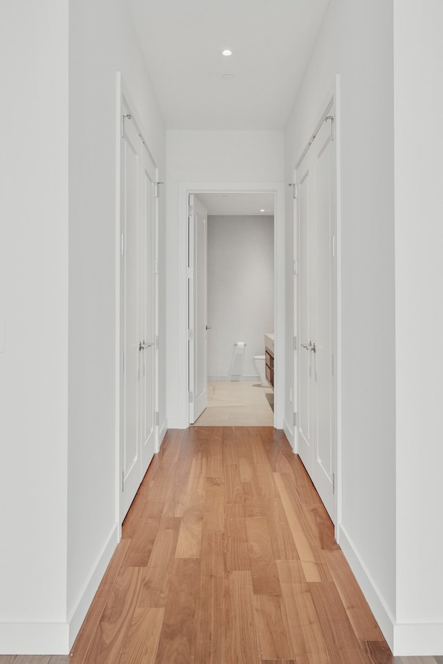 corridor with light hardwood / wood-style flooring