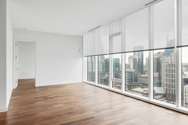 empty room with hardwood / wood-style floors