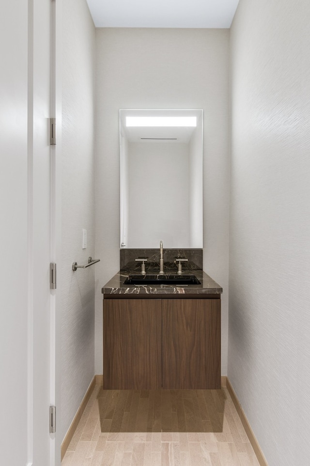 bathroom featuring wood-type flooring and vanity