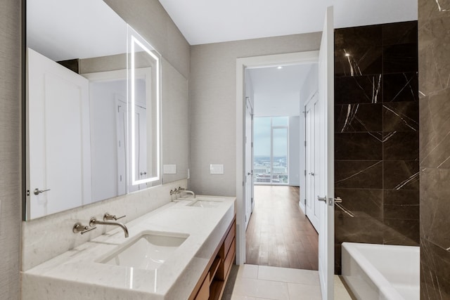 bathroom featuring vanity, a tub, and hardwood / wood-style flooring