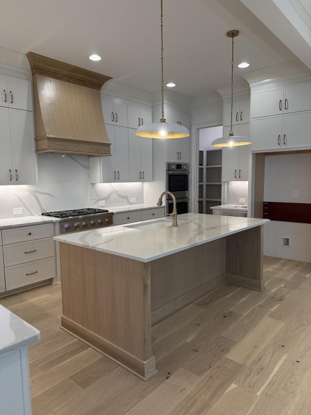 8006 Southvale Blvd, Franklin, TN 37064 - kitchen with stainless steel appliances, a sink, light wood finished floors, a large island, and recessed lighting