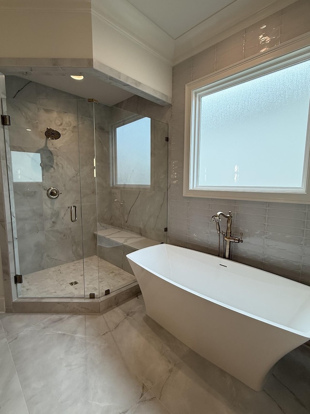8006 Southvale Blvd, Franklin, TN 37064 - bathroom featuring a freestanding bath, marble finish flooring, a stall shower, and tile walls