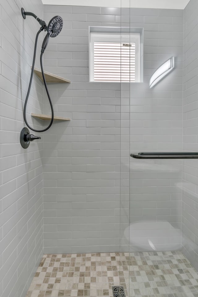 bathroom with a tile shower