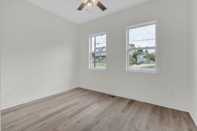 empty room with light hardwood / wood-style floors and ceiling fan