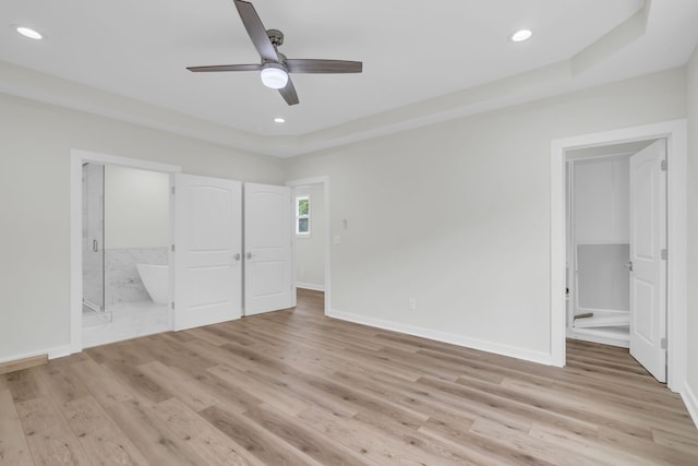 unfurnished bedroom with ceiling fan, connected bathroom, and light wood-type flooring