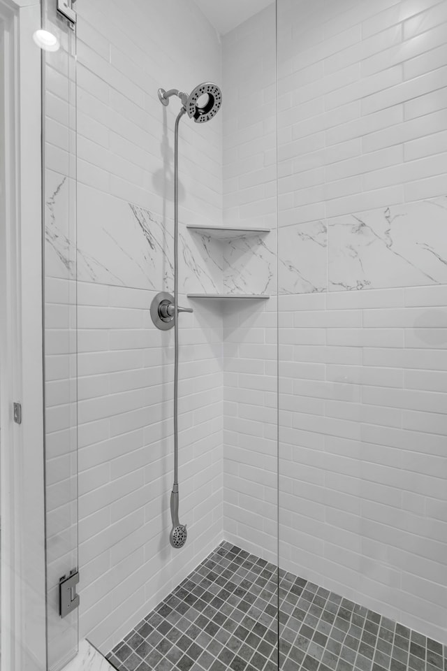 bathroom with a shower with door