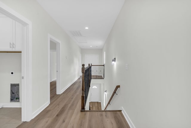 hallway with light hardwood / wood-style floors