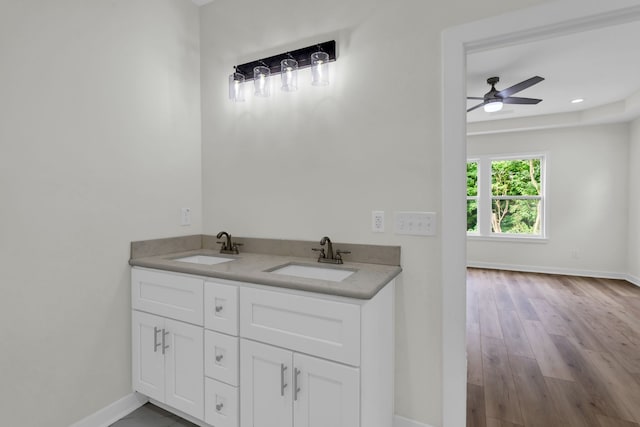 bathroom featuring ceiling fan, wood-type flooring, and vanity