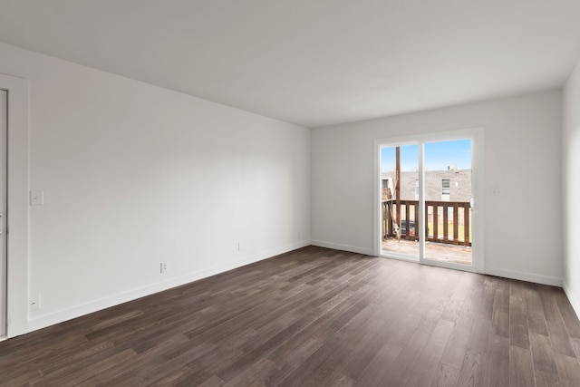 empty room with dark wood-type flooring