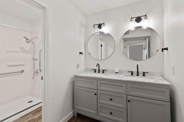 bathroom featuring a shower, hardwood / wood-style floors, and vanity