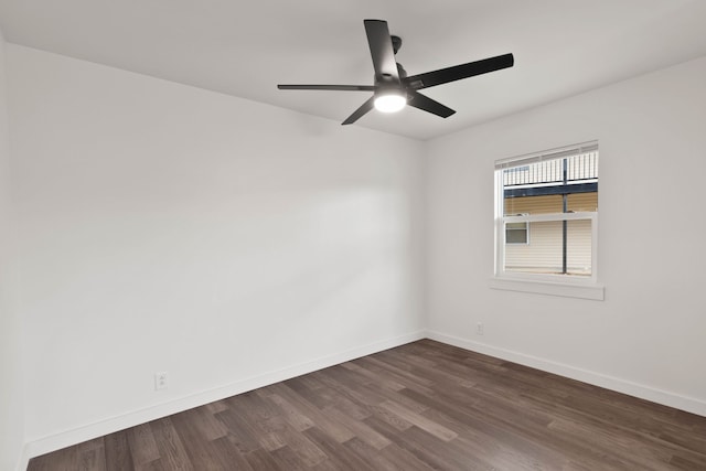 spare room with ceiling fan and dark hardwood / wood-style flooring