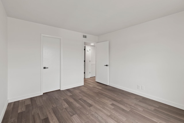 unfurnished bedroom featuring dark hardwood / wood-style flooring