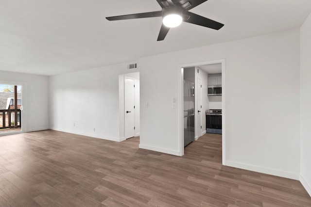 unfurnished room with hardwood / wood-style floors and ceiling fan