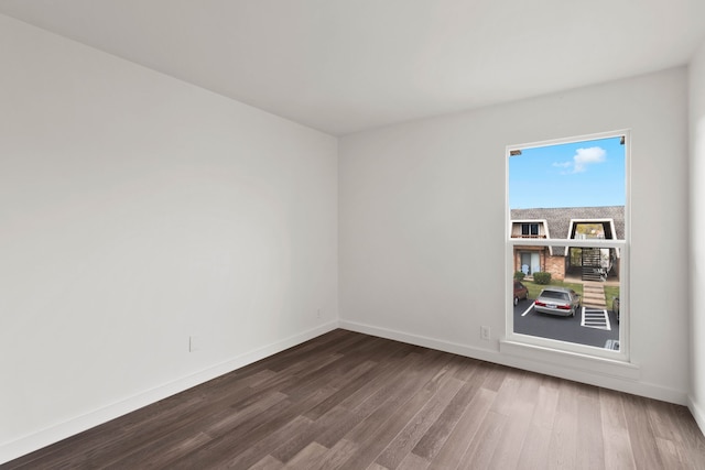 empty room with dark wood-type flooring