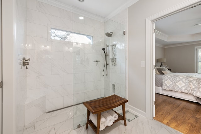 bathroom featuring hardwood / wood-style floors, crown molding, and a tile shower