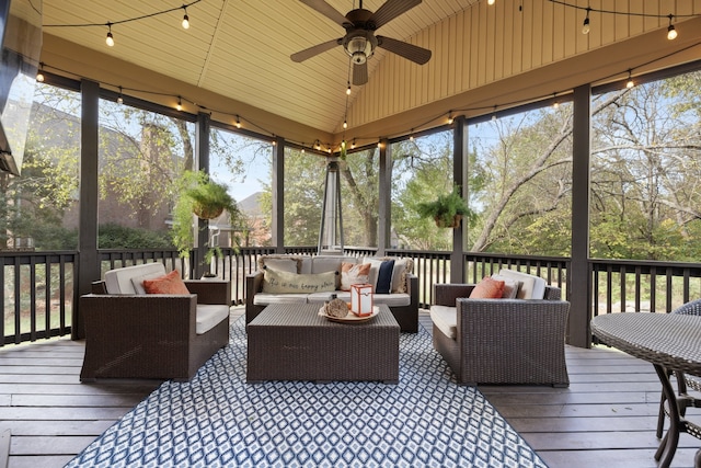 sunroom / solarium with lofted ceiling and ceiling fan