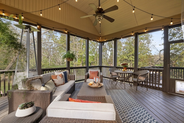 sunroom featuring wood ceiling, ceiling fan, and vaulted ceiling