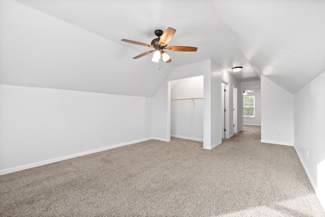 additional living space featuring ceiling fan, vaulted ceiling, and carpet