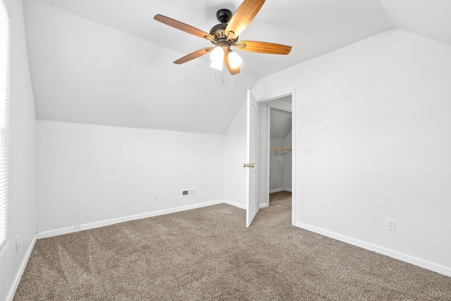 bonus room with lofted ceiling, carpet, and ceiling fan