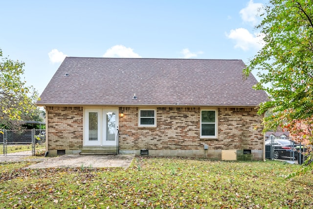 back of house with a yard and a patio