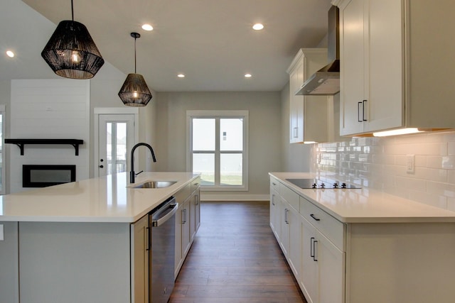 kitchen with stainless steel dishwasher, sink, a center island with sink, and wall chimney range hood