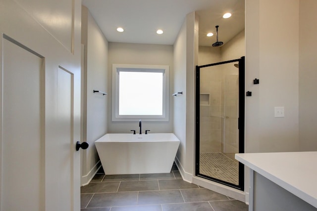 bathroom featuring plus walk in shower and tile patterned flooring