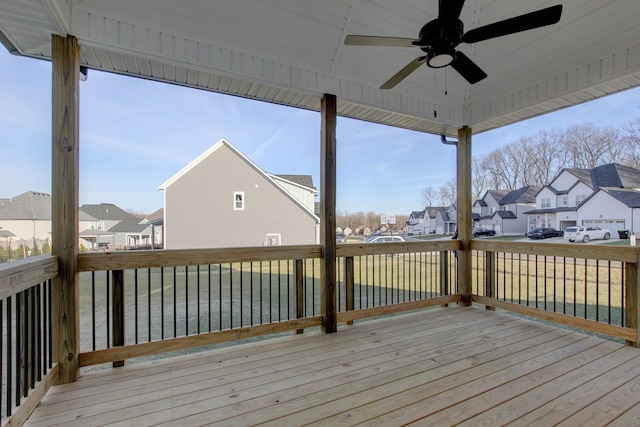 wooden deck with a yard and ceiling fan