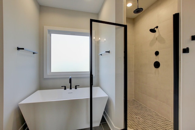 bathroom featuring independent shower and bath