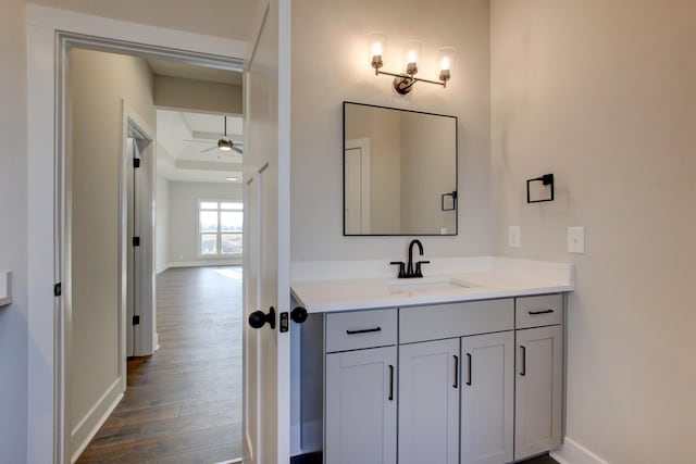 bathroom with hardwood / wood-style flooring, ceiling fan, and vanity