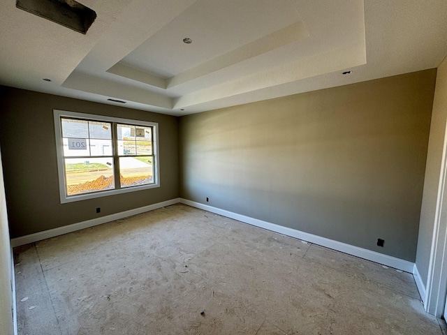 empty room with a raised ceiling