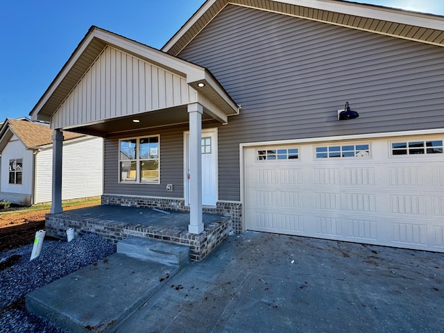 view of front of property with a porch and a garage