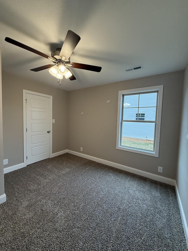 unfurnished room with ceiling fan and carpet