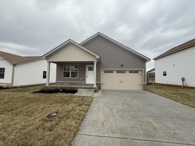 view of front of home featuring a garage, a front yard, and covered porch