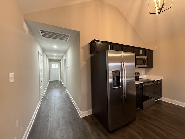 corridor with vaulted ceiling and dark hardwood / wood-style flooring