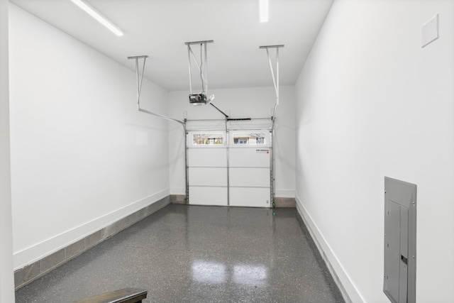 garage featuring baseboards, electric panel, and a garage door opener