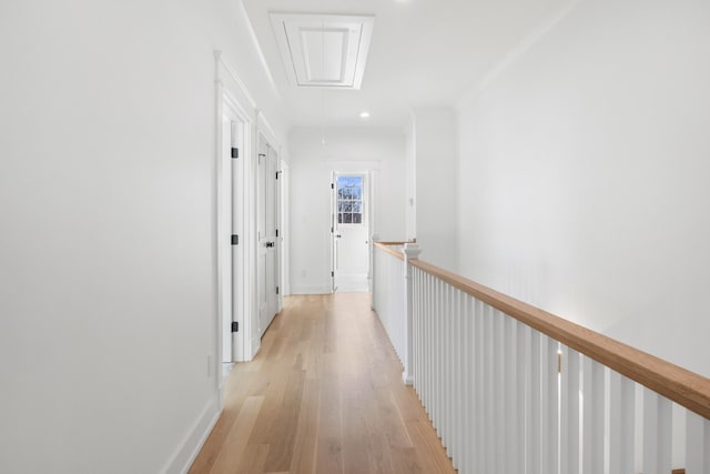 hallway featuring recessed lighting, light wood-type flooring, attic access, and baseboards