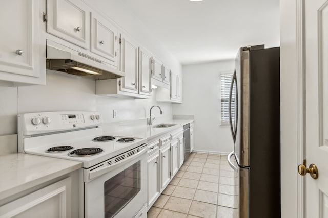 kitchen with white cabinetry, stainless steel appliances, sink, and light tile patterned floors