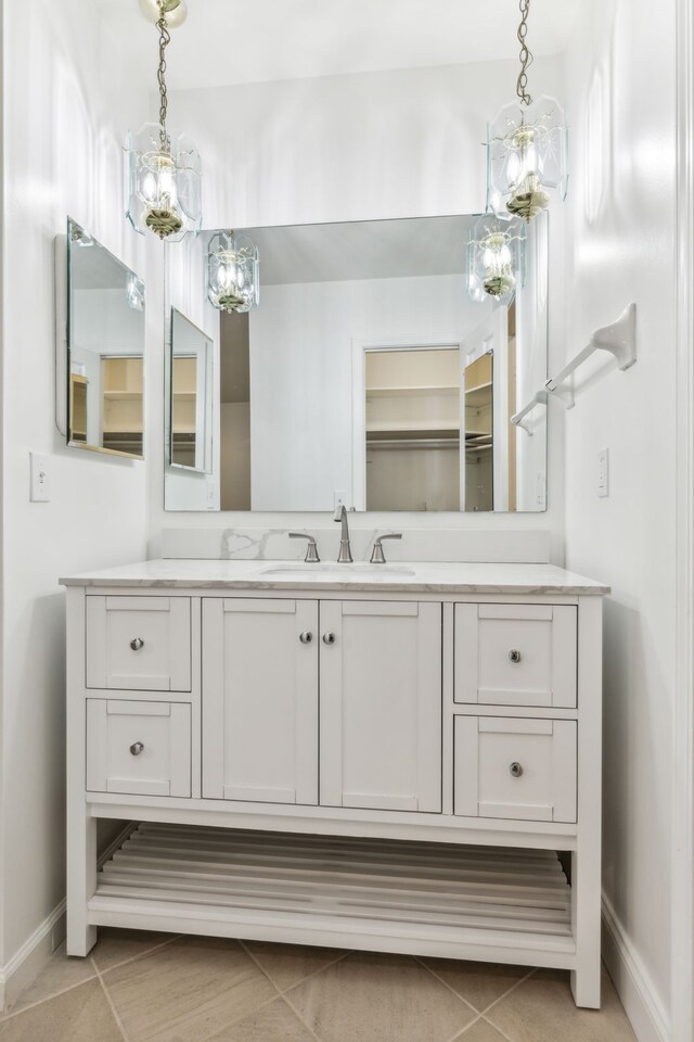 bathroom featuring tile patterned flooring and vanity