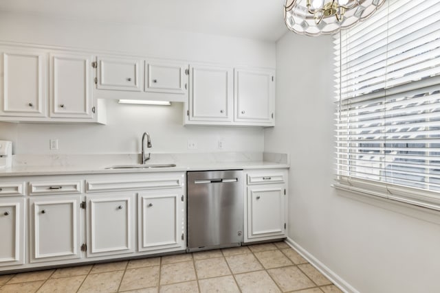 kitchen with stainless steel dishwasher, a chandelier, sink, and white cabinets