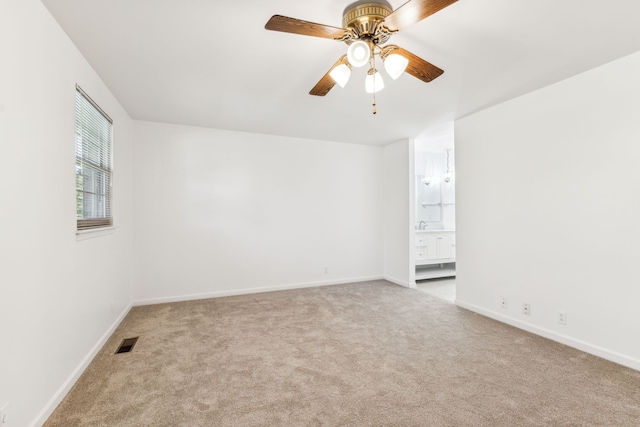 unfurnished room featuring ceiling fan and light carpet