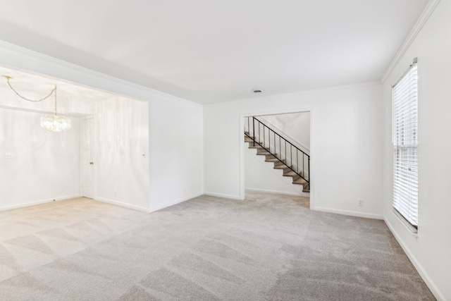 carpeted empty room with a chandelier, a wealth of natural light, and ornamental molding