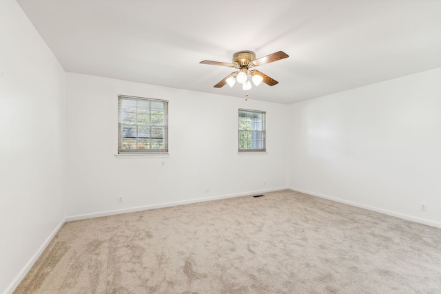 carpeted empty room with ceiling fan